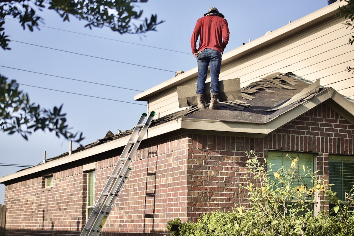 Inspecting storm damage on Irving residential roof